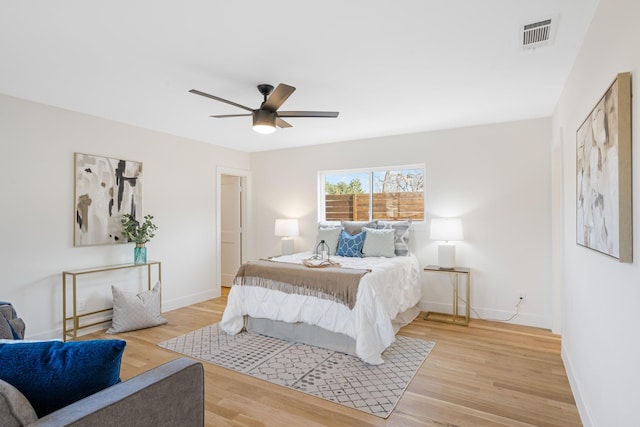 bedroom with ceiling fan and light hardwood / wood-style floors