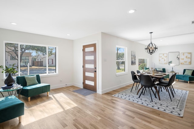dining space with light wood-type flooring and recessed lighting