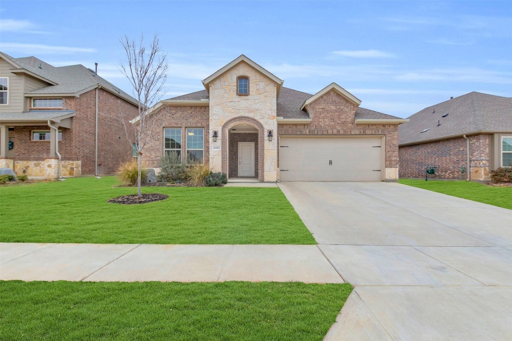 view of front of house with a garage and a front lawn