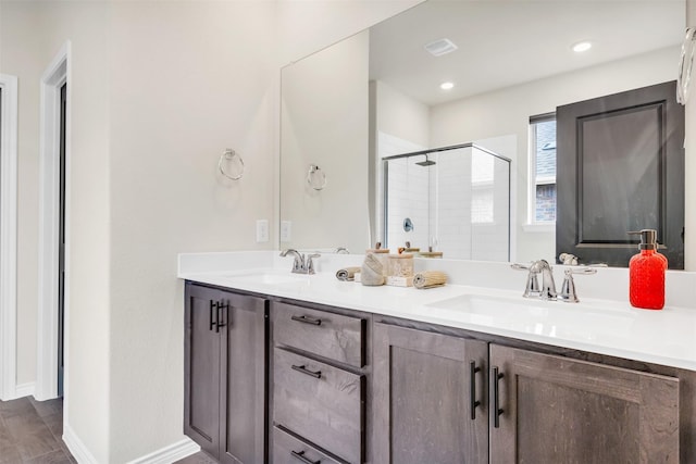 bathroom featuring walk in shower and vanity