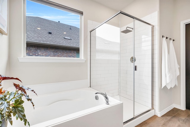 bathroom featuring wood-type flooring and shower with separate bathtub