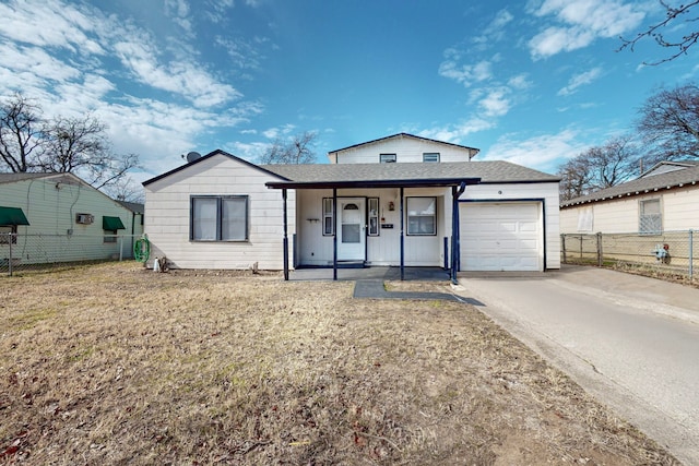 view of front of property featuring a garage, a porch, and a front lawn