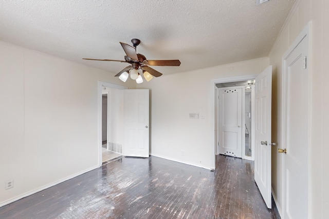 unfurnished room featuring ceiling fan, dark hardwood / wood-style floors, and a textured ceiling