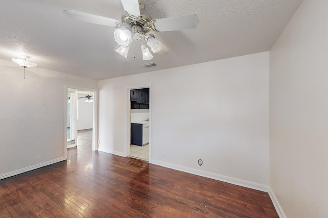 empty room featuring ceiling fan, wood-type flooring, and a textured ceiling