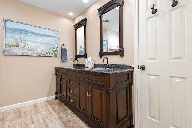 bathroom with wood-type flooring and vanity