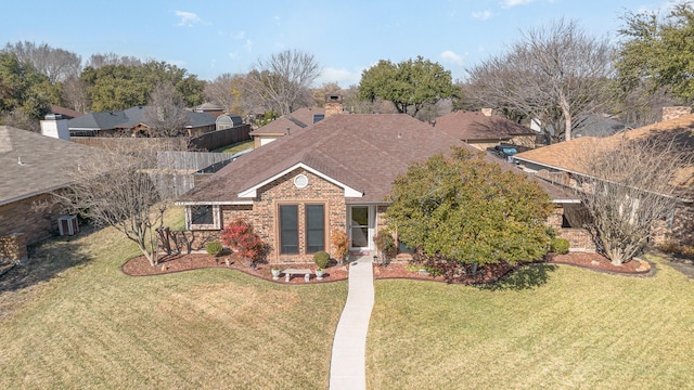 view of front of property with central AC and a front lawn