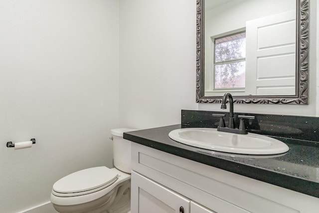 bathroom featuring vanity and toilet