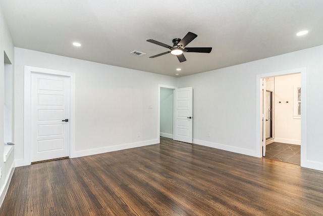 unfurnished room featuring dark wood-type flooring and ceiling fan