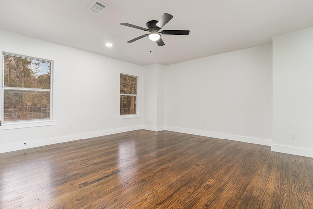 empty room featuring dark wood-type flooring and ceiling fan