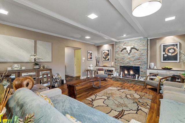 living room with crown molding, beam ceiling, a stone fireplace, and dark wood-type flooring