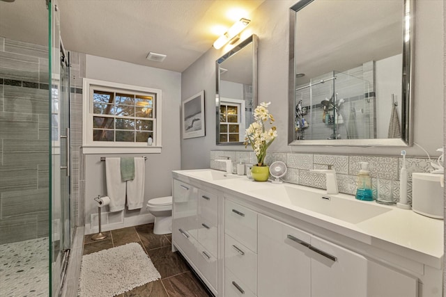 bathroom with walk in shower, vanity, toilet, and decorative backsplash