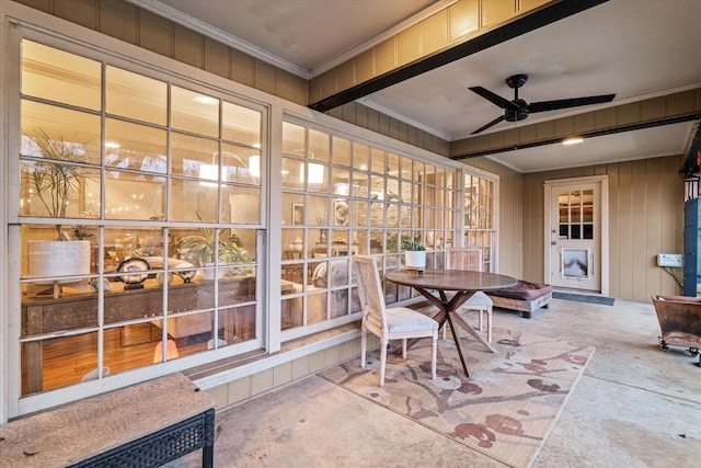 sunroom / solarium featuring ceiling fan