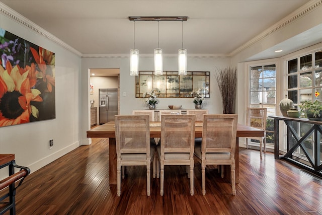 dining area with ornamental molding, dark hardwood / wood-style floors, and track lighting