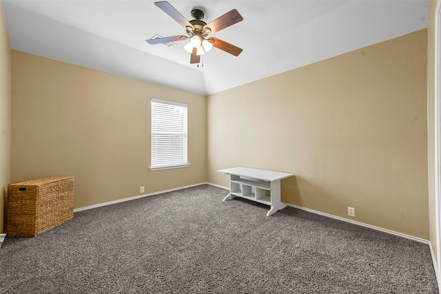 carpeted empty room featuring ceiling fan and vaulted ceiling