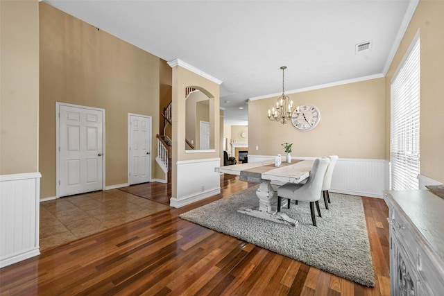 dining room featuring a notable chandelier, crown molding, and dark wood-type flooring