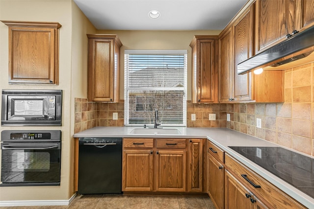 kitchen featuring backsplash, light tile patterned floors, sink, and black appliances