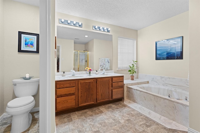 full bathroom with vanity, a textured ceiling, toilet, and separate shower and tub