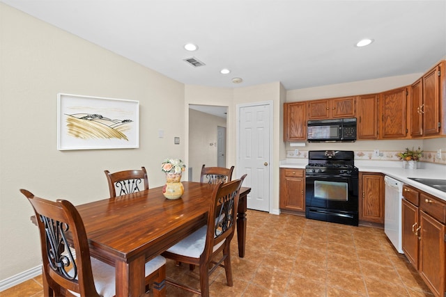 kitchen with sink, light tile patterned floors, and black appliances