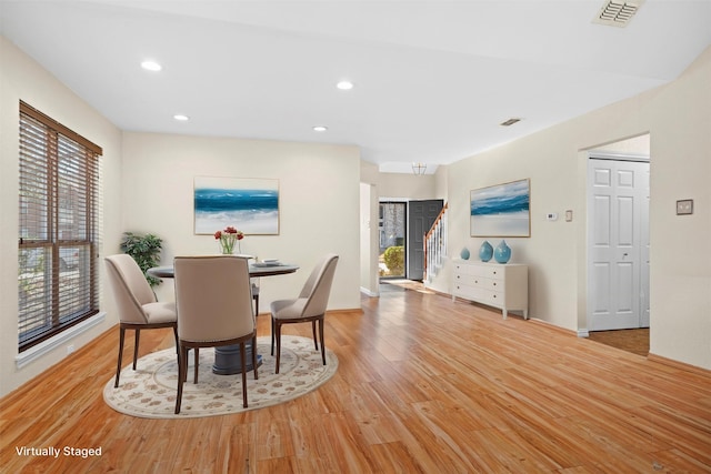 dining space with a wealth of natural light and light hardwood / wood-style floors