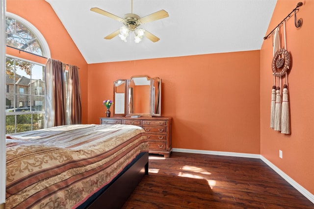 bedroom featuring multiple windows, lofted ceiling, dark hardwood / wood-style floors, and ceiling fan