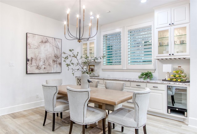 dining area with wine cooler and light hardwood / wood-style floors