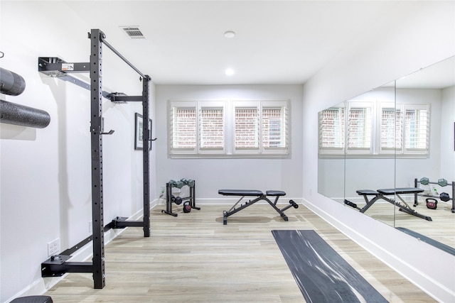 exercise area with hardwood / wood-style floors and a wealth of natural light