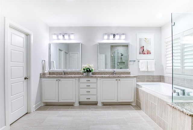 bathroom featuring vanity, tile patterned flooring, and plus walk in shower