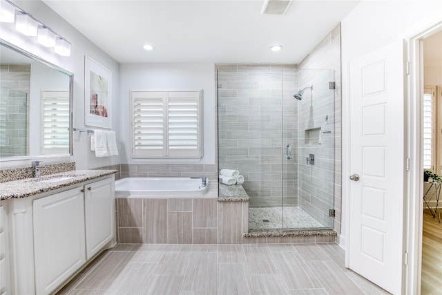 bathroom with vanity, plus walk in shower, tile patterned flooring, and plenty of natural light