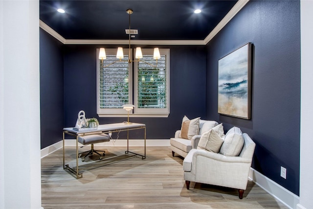 office area with hardwood / wood-style flooring, ornamental molding, and a chandelier