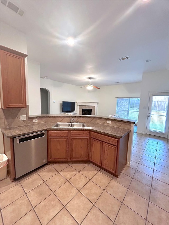 kitchen with tasteful backsplash, sink, stainless steel dishwasher, light tile patterned floors, and ceiling fan