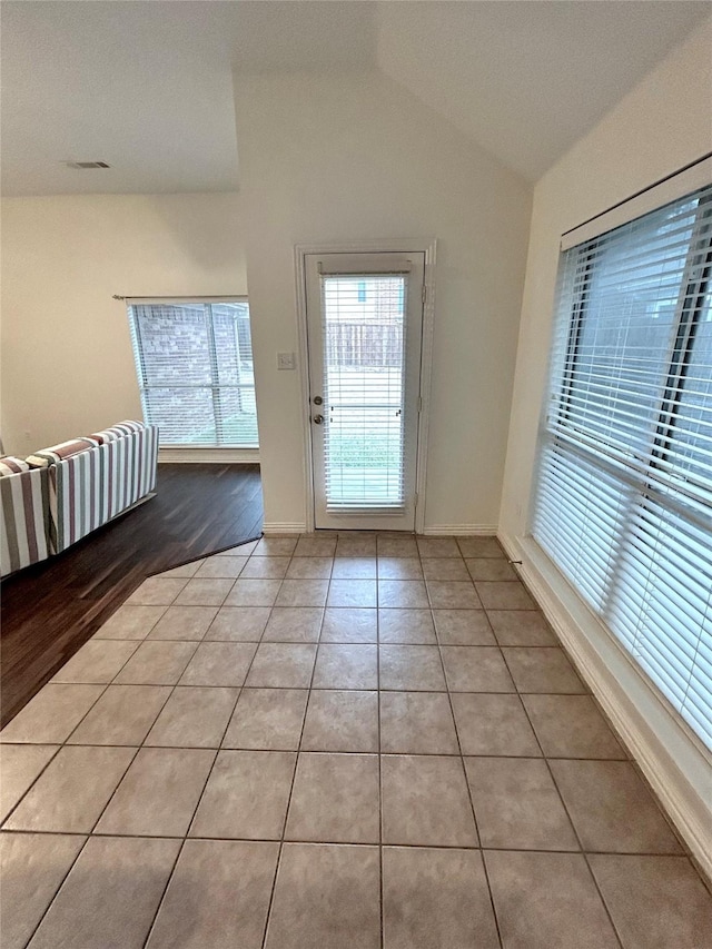 5420 Centeridge Ln, Mckinney, TX 75071 - doorway to outside featuring light tile patterned floors, lofted ceiling, and baseboards
