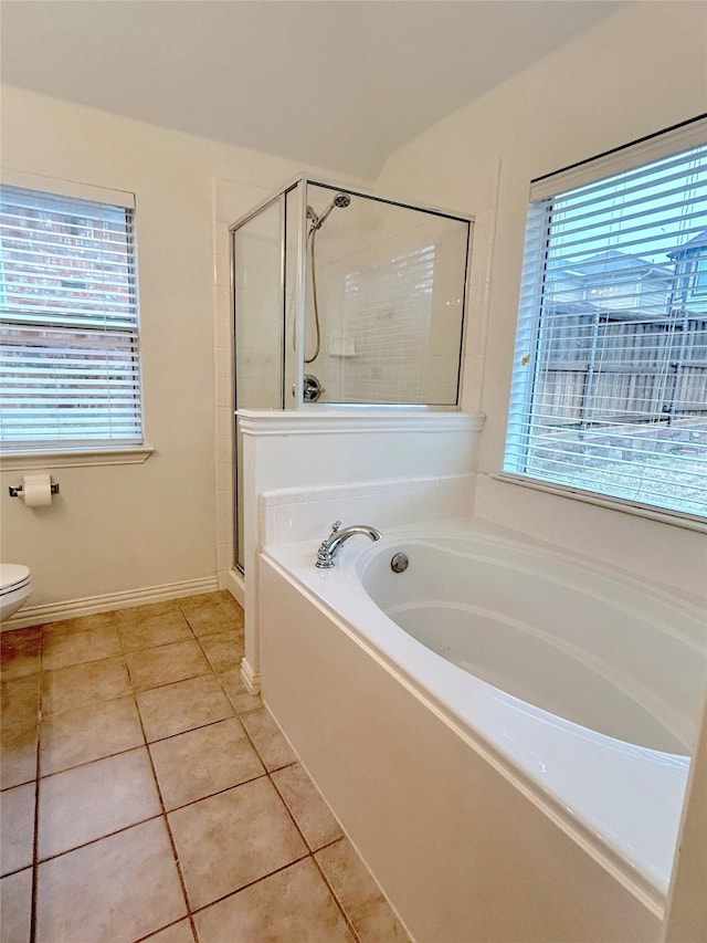 bathroom with tile patterned flooring, toilet, and separate shower and tub