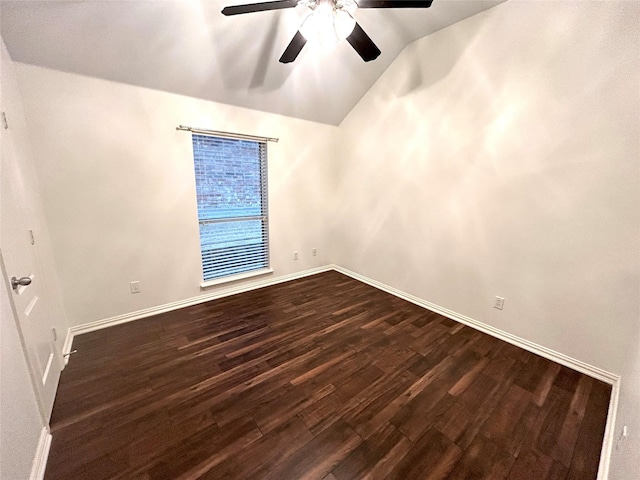 empty room with lofted ceiling, dark hardwood / wood-style floors, and ceiling fan