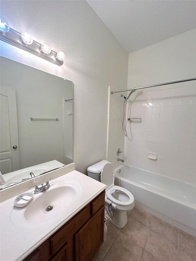 full bathroom featuring tiled shower / bath, tile patterned floors, toilet, and vanity