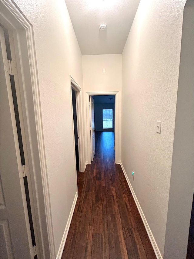 5420 Centeridge Ln, Mckinney, TX 75071 - hallway featuring dark wood-style floors, baseboards, and a textured wall