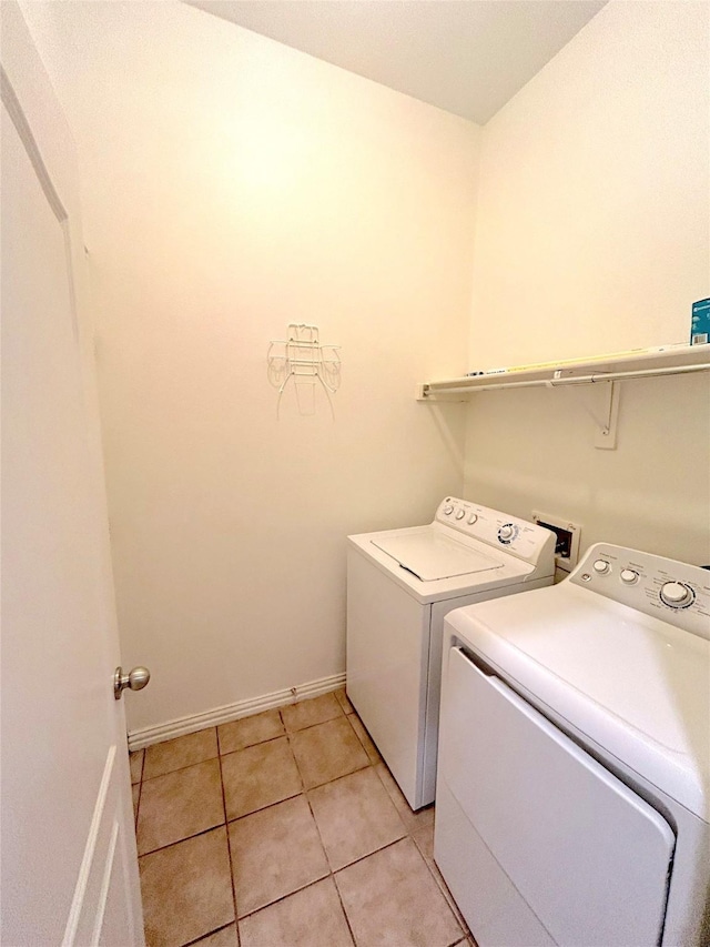 laundry room with light tile patterned flooring and independent washer and dryer