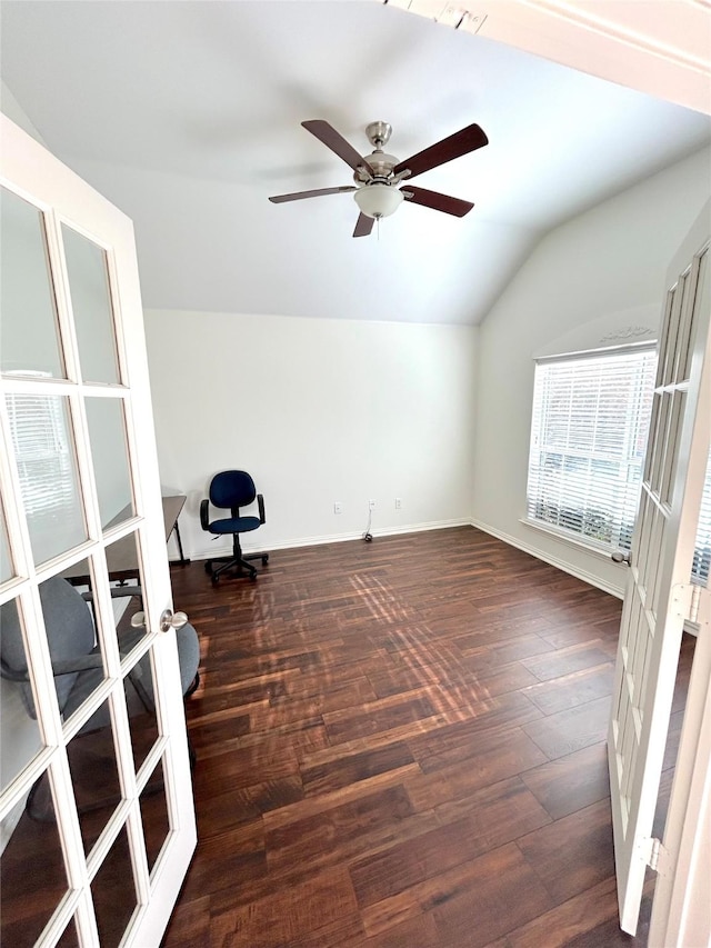 empty room featuring lofted ceiling, dark wood-type flooring, ceiling fan, and french doors