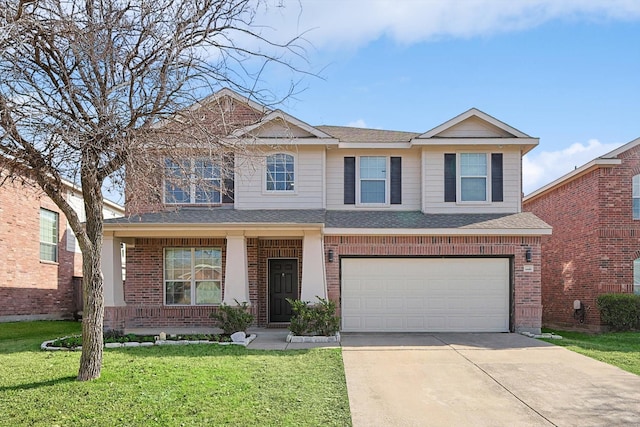 view of front of property featuring a garage, a front yard, and covered porch