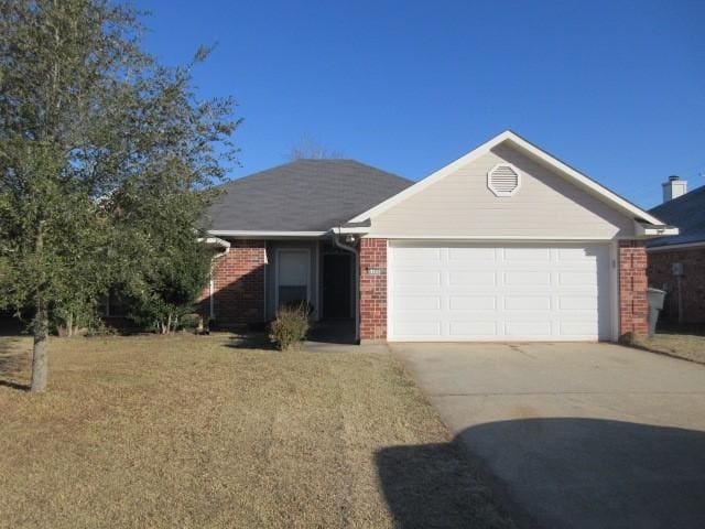 ranch-style house featuring a garage and a front lawn