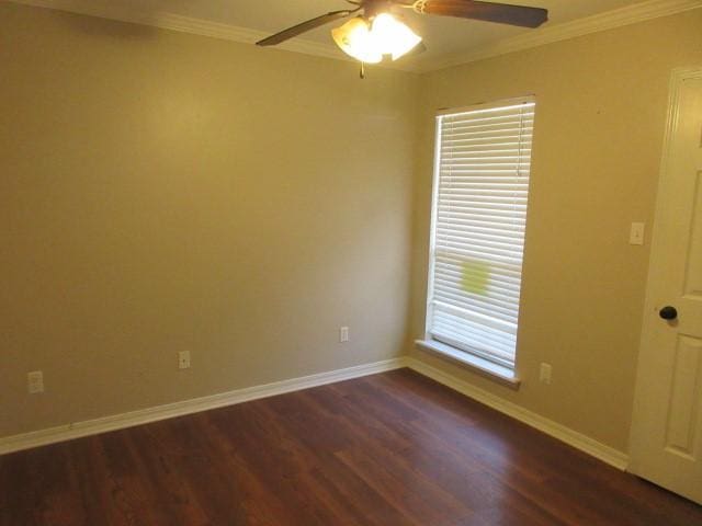 spare room featuring ornamental molding, dark wood-type flooring, and ceiling fan