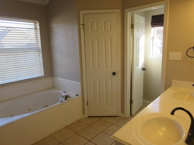 bathroom with vanity, a tub to relax in, a wealth of natural light, and tile patterned floors