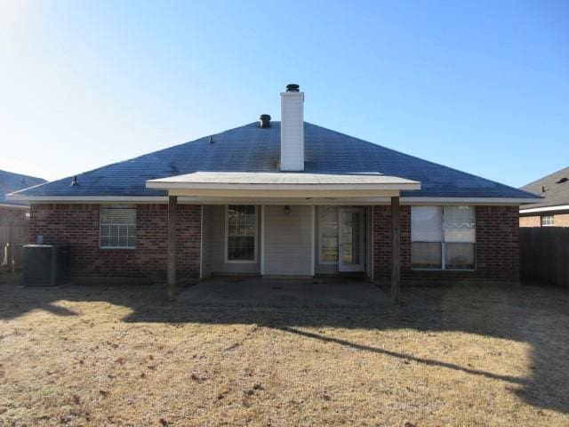 back of property featuring a patio, central AC unit, and a lawn