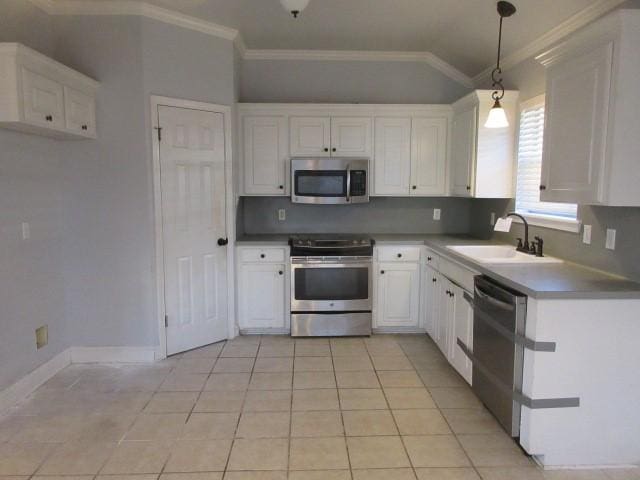 kitchen featuring stainless steel appliances, sink, white cabinets, and decorative light fixtures