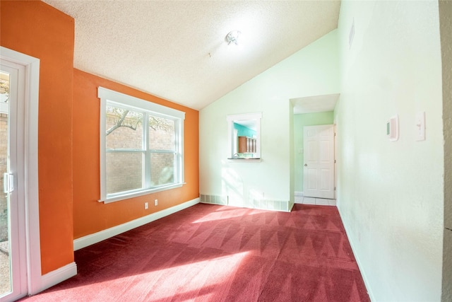 interior space with lofted ceiling and a textured ceiling