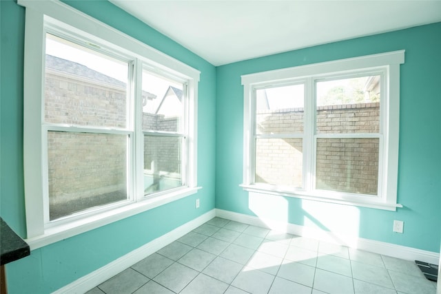 unfurnished room with light tile patterned floors