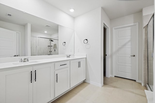 bathroom with vanity, an enclosed shower, and tile patterned floors