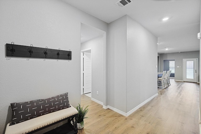 hallway with hardwood / wood-style floors