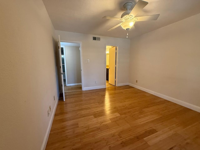 unfurnished bedroom with connected bathroom, light hardwood / wood-style floors, and ceiling fan