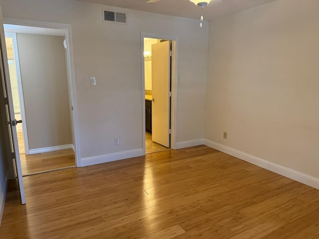 unfurnished bedroom featuring light hardwood / wood-style flooring and ensuite bathroom