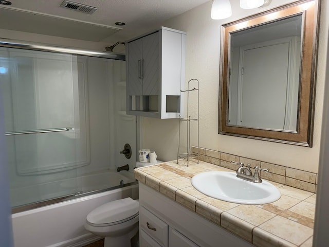 full bathroom featuring vanity, toilet, and combined bath / shower with glass door